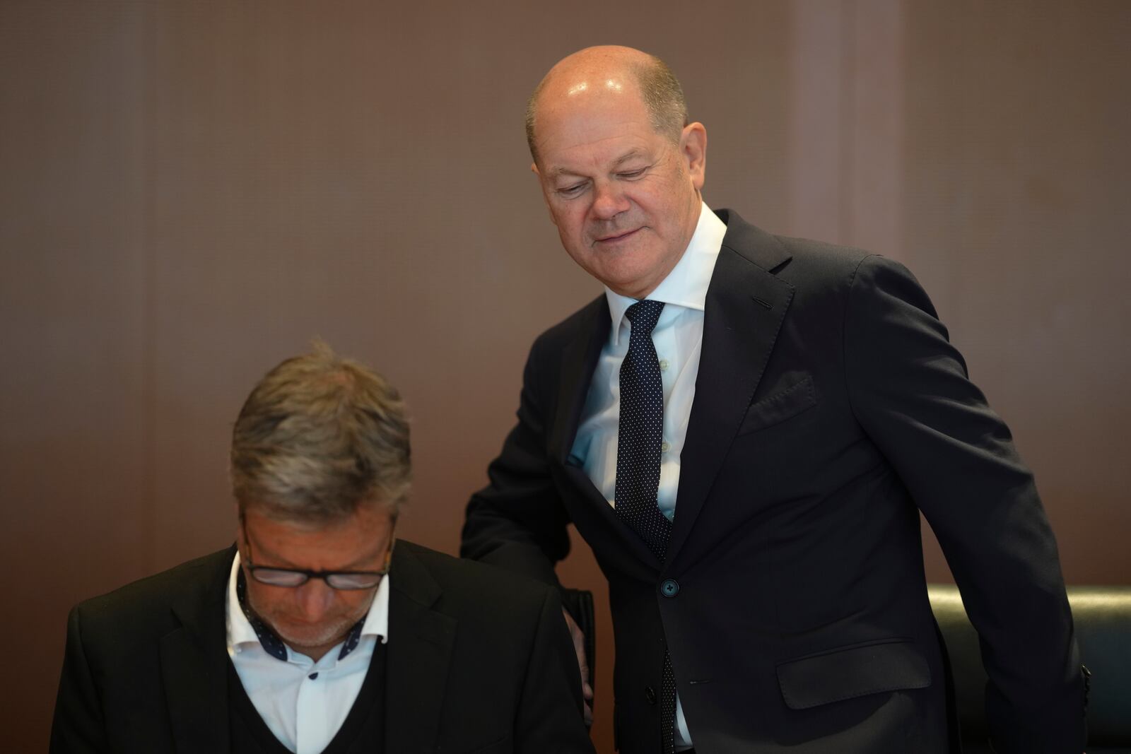 German Chancellor Olaf Scholz, right, takes his seat next to German Vice Chancellor and Economy and Climate Minister Robert Habeck, as he arrives for the weekly cabinet meeting at the chancellery in Berlin, Germany, Wednesday, Nov. 6, 2024. (AP Photo/Markus Schreiber)