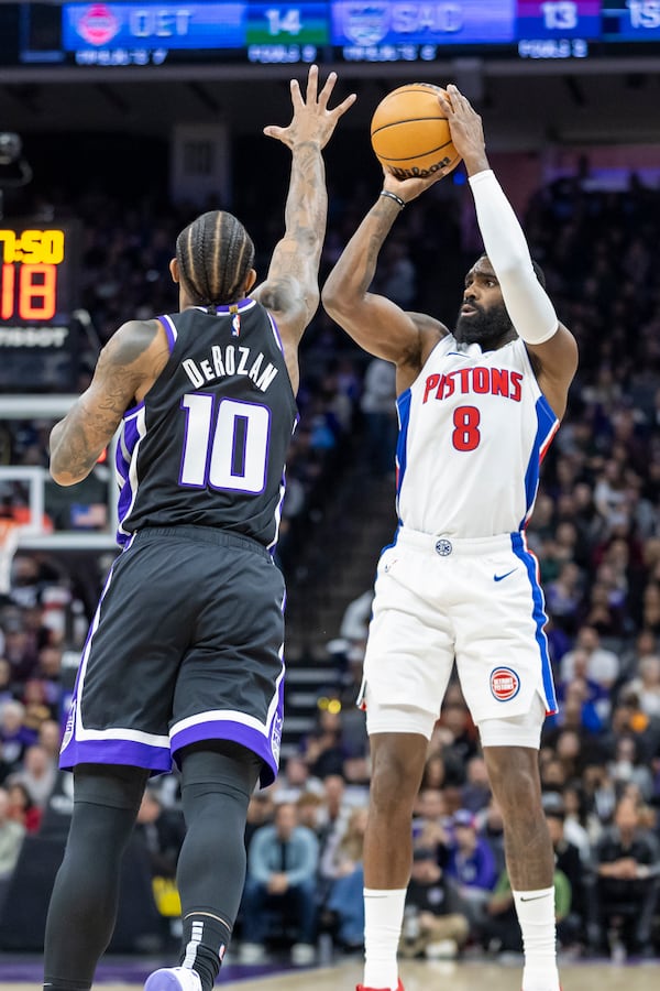 Detroit Pistons forward Tim Hardaway Jr. (8) prepares to shoot a 3-point basket over Sacramento Kings forward DeMar DeRozan (10) during the first half of an NBA basketball game Thursday, Dec. 26, 2024, in Sacramento, Calif. (AP Photo/Sara Nevis)