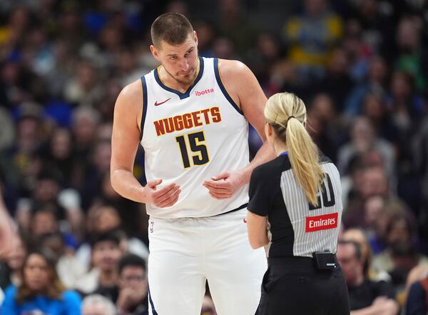 Denver Nuggets center Nikola Jokic argues after being called for a foul by referee Jenna Schroeder in the second half of an NBA basketball game against the Atlanta Hawks Wednesday, Jan. 1, 2025, in Denver. (AP Photo/David Zalubowski)