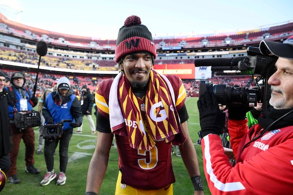 Washington Commanders quarterback Jayden Daniels (5) heads off the field at the end of an NFL football game against the Philadelphia Eagles, Sunday, Dec. 22, 2024, in Landover, Md. (AP Photo/Nick Wass)