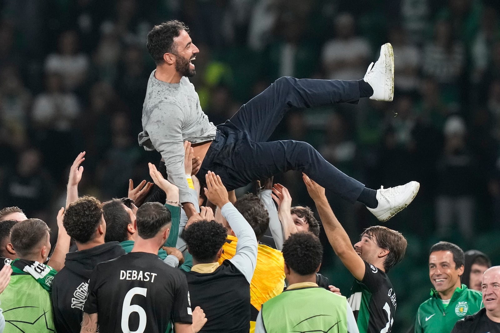 Sporting players toss coach Ruben Amorim during the UEFA Champions League opening phase match between Sporting and Manchester City in Lisbon, Portugal, Tuesday, Nov. 5, 2024. (AP Photo/Armando Franca)