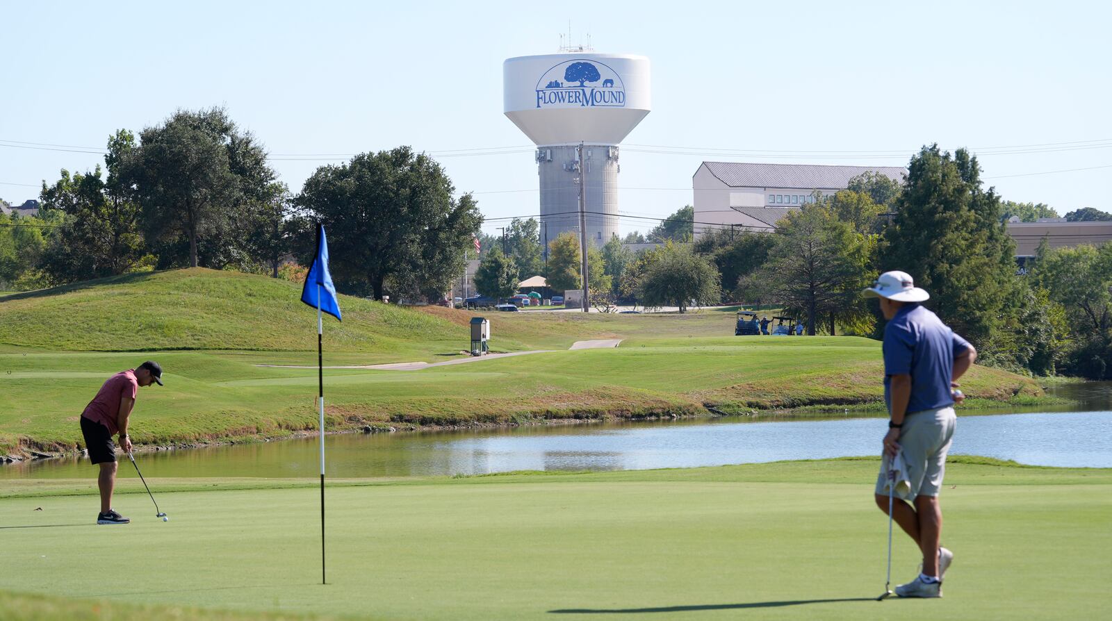 People play golf in Flower Mound, Texas, Friday, Oct. 4, 2024. (AP Photo/LM Otero)