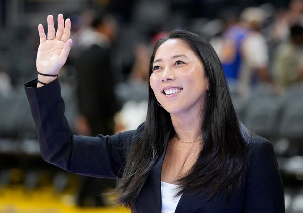 FILE - Golden State Valkyries WNBA head coach Natalie Nakase waves before an NBA preseason basketball game between the Golden State Warriors and the Sacramento Kings in San Francisco, Oct. 11, 2024. (AP Photo/Jeff Chiu, File)