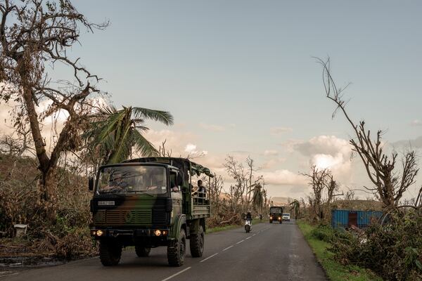 French military vehicles make their way to the central city of Mirereni, Mayotte, Friday, Dec. 20, 2024. (AP Photo/Adrienne Surprenant)