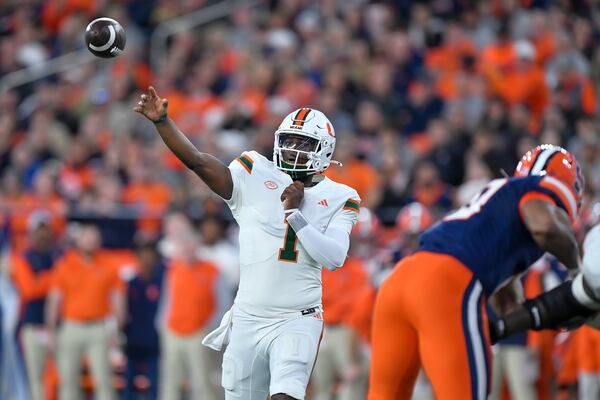 Miami quarterback Cam Ward (1) throws during the first half of an NCAA football game against Syracuse on Saturday, Nov. 30, 2024 in Syracuse, N.Y. (AP Photo/Adrian Kraus)