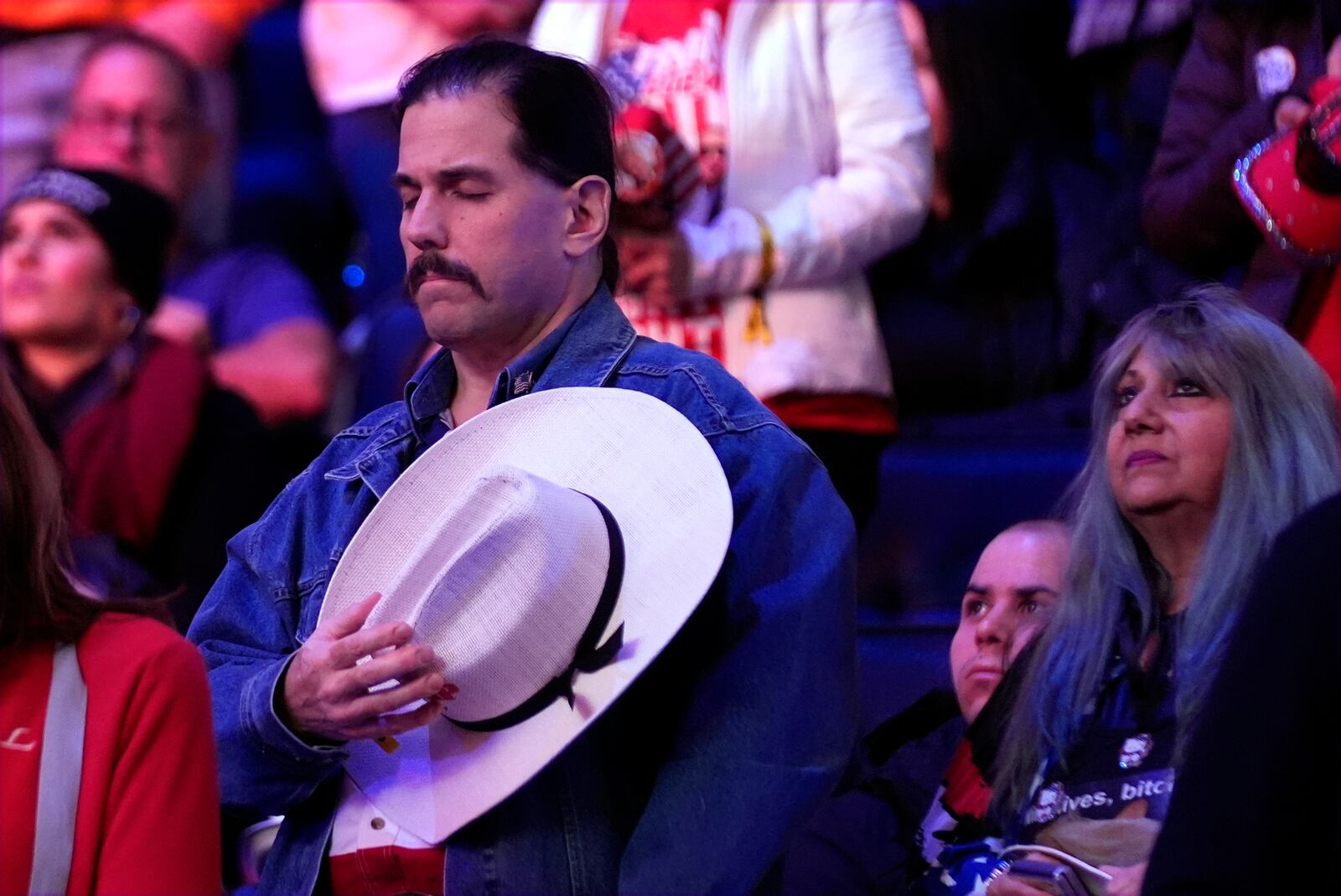 Supporters pray before Republican presidential nominee former President Donald Trump speaks at a campaign rally at Madison Square Garden, Sunday, Oct. 27, 2024, in New York. (AP Photo/Alex Brandon)