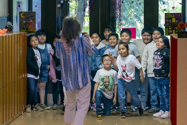 Second grade teacher Lori Spina taking a photo of her class for her newsletter Tuesday, Oct. 1, 2024, at Algodones Elementary School in Algodones, N.M. (AP Photo/Roberto E. Rosales)