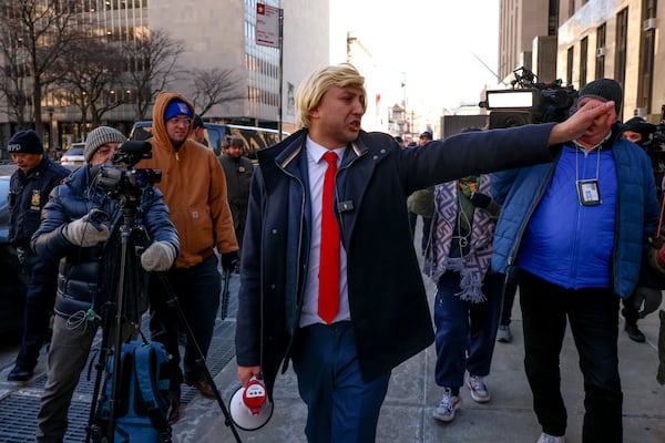 A man impersonating President-elect Donald Trump walks outside Manhattan criminal court before the start of the sentencing in Trump's hush money case, Friday, Jan. 10, 2025, in New York. (AP Photo/Yuki Iwamura)