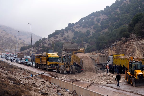 Displaced residents returning from Syria sit in traffic as roadworks get underway to reopen the Masnaa border crossing, eastern Lebanon, following a ceasefire between Israel and Hezbollah on Wednesday, Nov. 27, 2024. (AP Photo/Hassan Ammar)