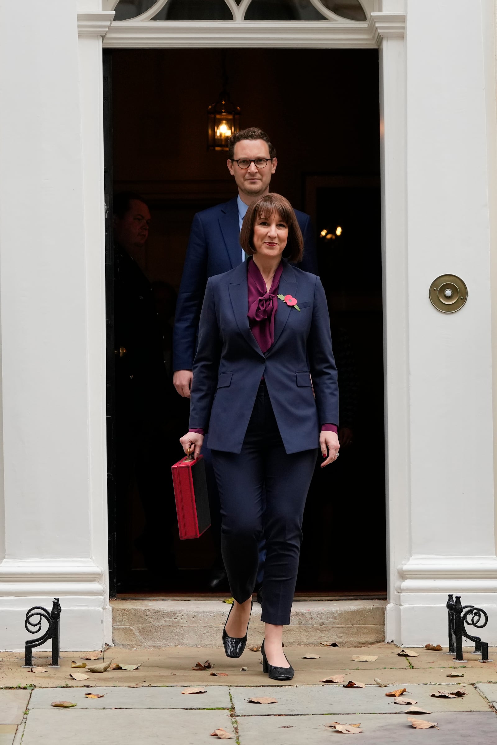 Britain's Chancellor of the Exchequer, Rachel Reeves, walks out of 11 Downing Street holding the traditional red ministerial box containing her budget speech, before departing to the House of Commons to deliver the budget in London, Wednesday, Oct. 30, 2024, behind her is Darren Jones, Chief Secretary to the Treasury.(AP Photo/Kirsty Wigglesworth)