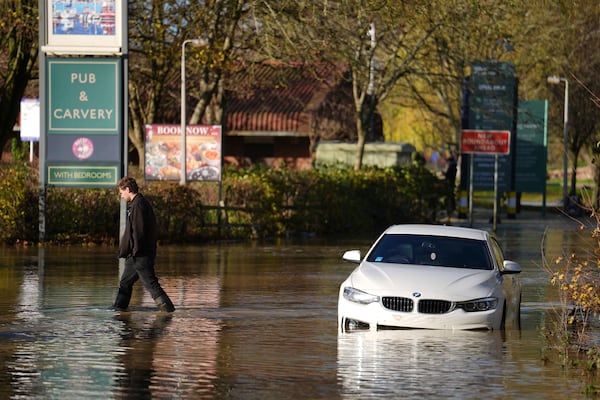 A stranded car in flood water at the Billing Aquadrome as Storm Bert continues to cause disruption, in Northampton, England, Monday, Nov. 25, 2024. (Jordan Pettitt/PA via AP)