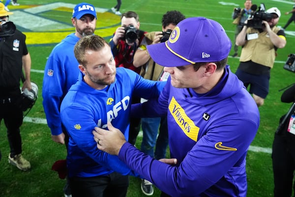 Los Angeles Rams head coach Sean McVay, left, and Minnesota Vikings head coach Kevin O'Connell talk after an NFL wild card playoff football game, Monday, Jan. 13, 2025, in Glendale, Ariz. (AP Photo/Ross D. Franklin)