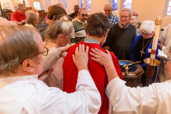 Faithful pray at a religious service in the aftermath of the Eaton Fire at Trinity Lutheran Church Sunday, Jan. 12, 2025 in Pasadena, Calif. (AP Photo/Ethan Swope)