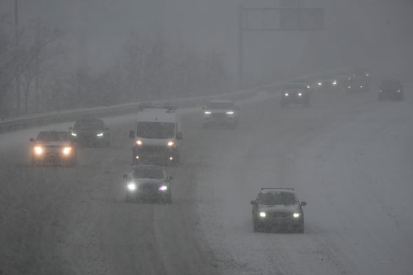 Vehicles drive along a highway during a winter storm, Sunday, Jan. 5, 2025, in Cincinnati. (AP Photo/Joshua A. Bickel)