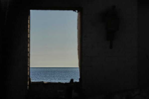 The Pacific Ocean is seen through the window of a home destroyed by the Palisades Fire, Thursday, Jan. 16, 2025, in Malibu, Calif. (AP Photo/Jae C. Hong)