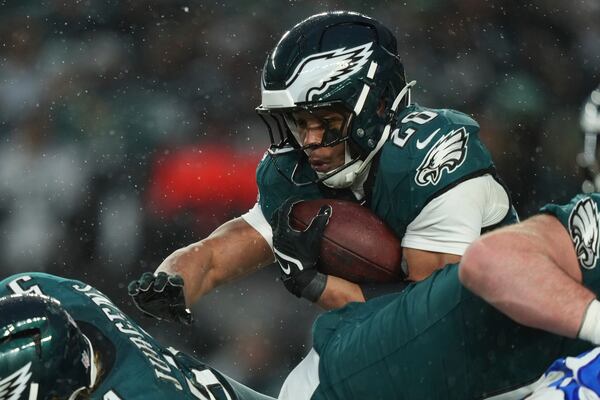 Philadelphia Eagles running back Saquon Barkley (26) runs with the ball during the first half of an NFL football NFC divisional playoff game against the Los Angeles Rams on Sunday, Jan. 19, 2025, in Philadelphia. (AP Photo/Matt Slocum)