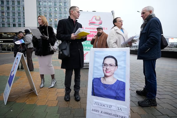 Belarusian presidential candidate Hanna Kanapatskaya, 2nd right, speaks with a man as she stands at an agitation picket ahead of presidential elections in Minsk, Belarus, Friday, Jan. 24, 2025. (AP Photo/Pavel Bednyakov)