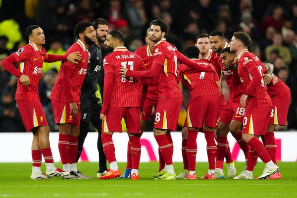 Liverpool players get together just before the start of the English Premier League soccer match between Tottenham and Liverpool at Tottenham Hotspur Stadium in London, Sunday, Dec. 22, 2024. (AP Photo/Dave Shopland)