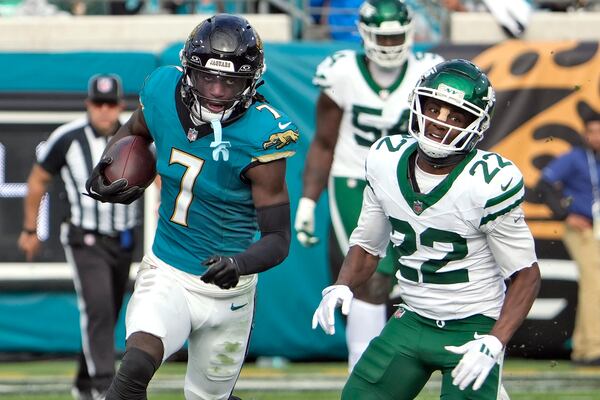 Jacksonville Jaguars wide receiver Brian Thomas Jr. (7) runs past New York Jets safety Tony Adams (22) after a catch during the second half of an NFL football game Sunday, Dec. 15, 2024, in Jacksonville, Fla. (AP Photo/John Raoux)