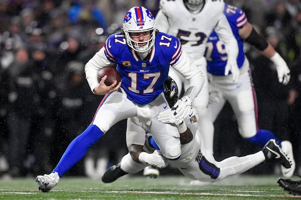 Buffalo Bills quarterback Josh Allen (17) is tackled by Baltimore Ravens defensive tackle Nnamdi Madubuike (92) during the first quarter of an NFL divisional playoff football game, Sunday, Jan. 19, 2025, in Orchard Park, N.Y. (AP Photo/Adrian Kraus)