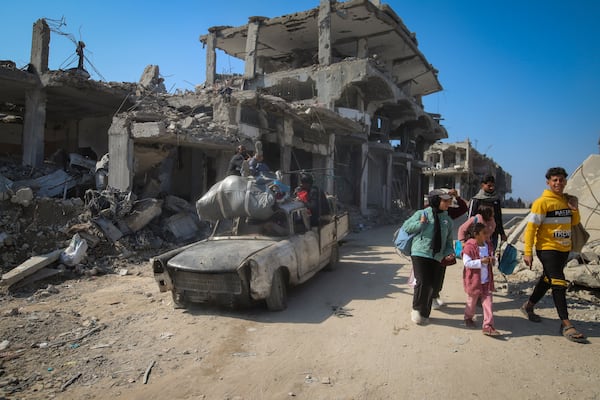 Displaced Palestinians arrive to Beit Lahia, northern Gaza Strip, Wednesday, Jan. 29, 2025, after Israel began allowing hundreds of thousands of Palestinians to return to the heavily damaged area last Monday. (AP Photo/Jehaid Alshrafi)