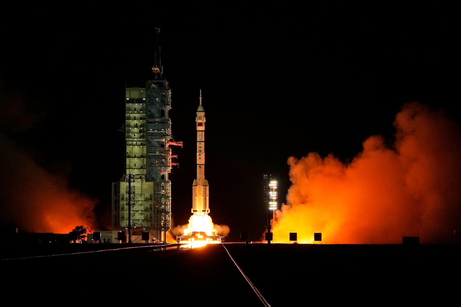 A Long March rocket with a Shenzhou-19 spacecraft atop takes off from the Jiuquan Satellite Launch Center in Jiuquan, northwestern China in the early hours of Wednesday, Oct. 30, 2024. (AP Photo/Ng Han Guan)