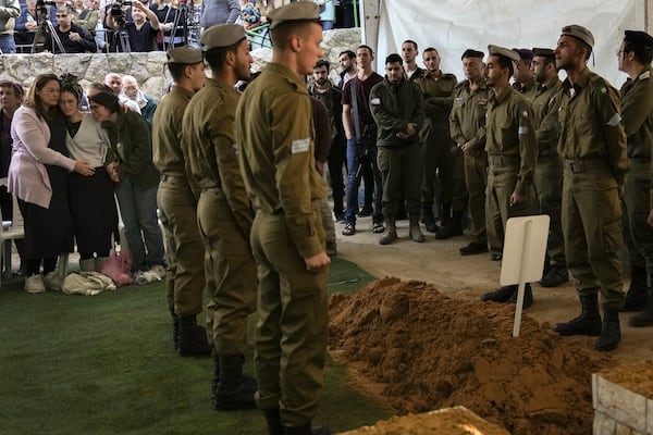 Close relatives, left, of combat engineer squad commander Staff Sgt. Zamir Burke, 20, from Beit Shemesh, mourn during his funeral at Mount Herzl military cemetery in Jerusalem, Israel, Sunday Nov. 1, 2024. Burke was killed in combat with Hamas at the Jabaliya refugee camp in Gaza. (APcPhoto/Mahmoud Illean)