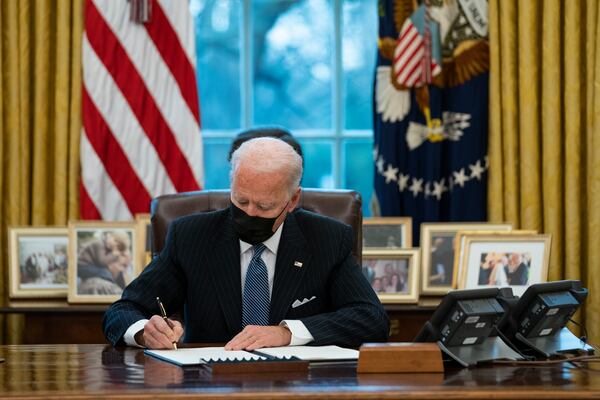 FILE - President Joe Biden signs an Executive Order reversing the Trump era ban on transgender individuals serving in military, in the Oval Office of the White House, Monday, Jan. 25, 2021, in Washington. (AP Photo/Evan Vucci, File)