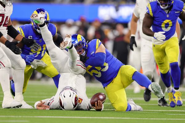 Arizona Cardinals quarterback Kyler Murray, left, is sacked by Los Angeles Rams defensive tackle Braden Fiske (55) during the first half of an NFL football game Saturday, Dec. 28, 2024, in Inglewood, Calif. (AP Photo/Ryan Sun)