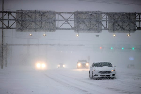 Motorists drive in heavy snow on N. Davis Highway on Tuesday, Jan. 21, 2025, in Pensacola, Fla. (Luis Santana/Tampa Bay Times via AP)