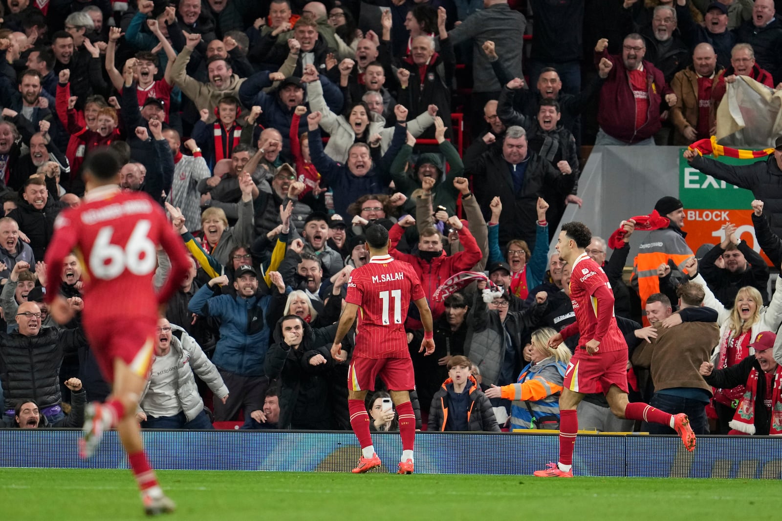 Liverpool's Mohamed Salah, centre, celebrates after scoring his side's second goal during the English Premier League soccer match between Liverpool and Brighton at the Anfield stadium in Liverpool, England, Saturday, Nov. 2, 2024. (AP Photo/Jon Super)