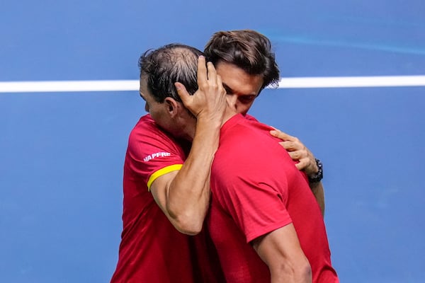 Spain's tennis player Rafael Nadal embraces David Ferrer, captain of Team Spain, after losing against Netherlands' Botic Van De Zandschulp during a Davis Cup quarterfinal match at Martin Carpena Sports Hall in Malaga, southern Spain, on Tuesday, Nov. 19, 2024. (AP Photo/Manu Fernandez)