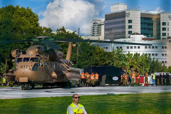 Israeli staff and military stand next to the military helicopter, carrying the four Israeli female soldier released from Gaza, after landing at the Beilinson hospital in Petah Tikva, near Tel Aviv, Israel, Saturday, Jan. 25, 2025. (AP Photo/Maya Alleruzzo)