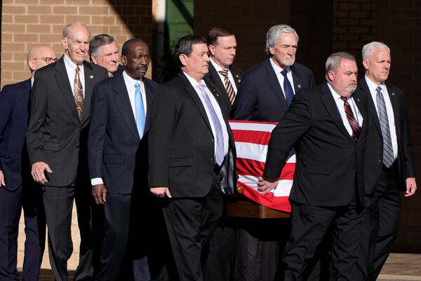 Former and current U.S. Secret Service agents assigned to the Carter detail, carry the flag-draped casket of former President Jimmy Carter, at Phoebe Sumter Medical Center in Americus, Ga., Saturday, Jan. 4, 2025. Carter died Dec. 29 at the age of 100. (AP Photo/Alex Brandon, Pool)