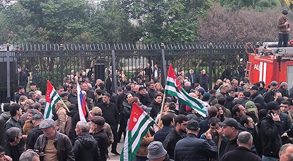 In this photo taken from video released by AIASHARA Independent Agency, Protesters with Abkhazian flags gather outside the parliament building of the Georgian separatist region of Abkhazia as tensions flared over a proposed pact that would allow Russians to buy apartments in the region, Georgia, on Friday, Nov. 15, 2024, (AIASHARA Independent Agency via AP)