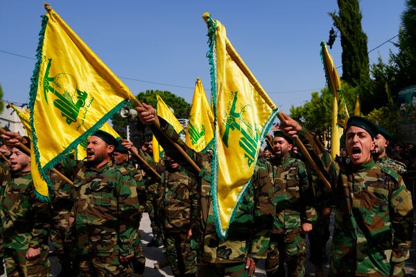 FILE - Hezbollah fighters attend the funeral procession of a Hezbollah militant who was killed by Israeli shelling, in south Lebanon, Oct. 22, 2023. (AP Photo/Hassan Ammar, File)