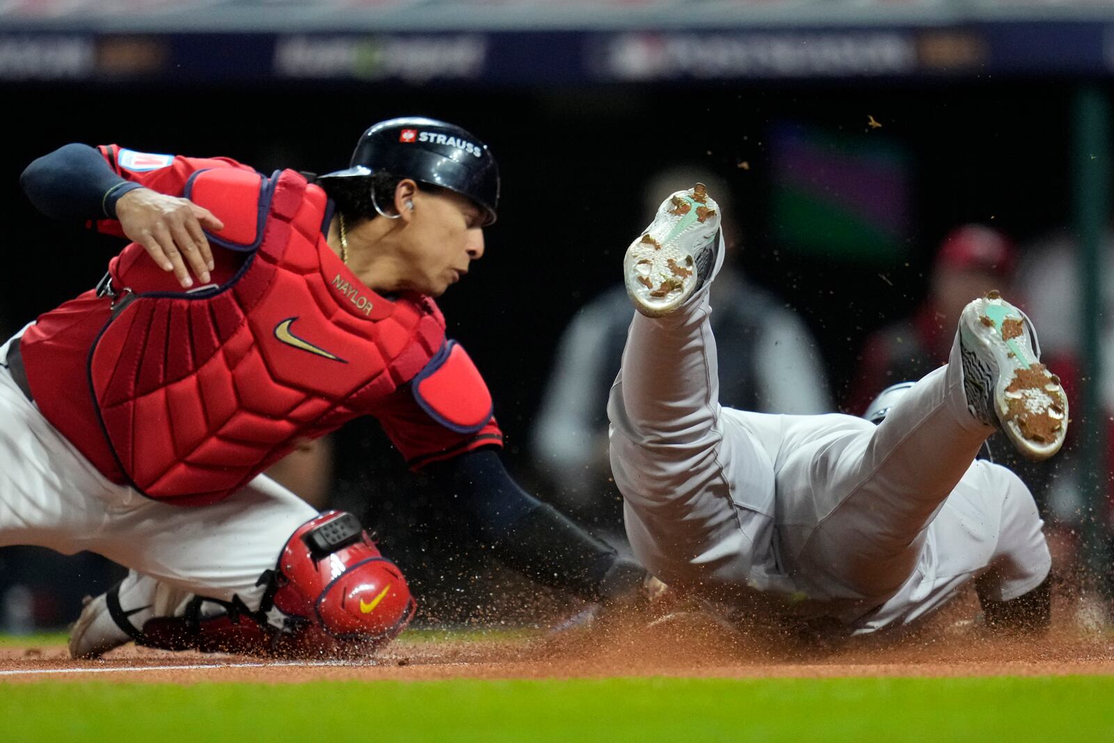 Cleveland Guardians catcher Bo Naylor tags New York Yankees' Gleyber Torres out at home plate during the first inning in Game 5 of the baseball AL Championship Series Saturday, Oct. 19, 2024, in Cleveland. (AP Photo/Sue Ogrocki)