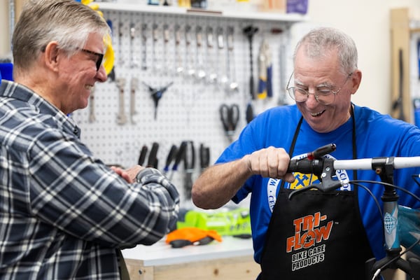 Volunteer Wayne Schafer, right, works on a bicycle while teaching new volunteer apprentice mechanic Paul Eisloeffel at Lincoln Bike Kitchen on Tuesday, Nov. 12, 2024, in Lincoln, Neb. (AP Photo/Rebecca S. Gratz)