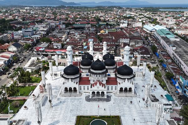 This aerial shot taken using a drone shows buildings at the business district surrounding Baiturrahman Grand Mosque which were badly ravaged by the Indian Ocean tsunami in 2004, in Banda Aceh , Indonesia, Thursday, Dec. 12, 2024. (AP Photo/Achmad Ibrahim)