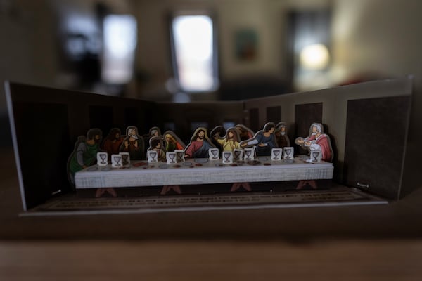 A paper cutout of The Last Supper, the last supper of Jesus with the Twelve Apostles, from the Gospel of John, is seen atop the piano in the Young's Sunbury, Ohio, home on Tuesday, Nov. 12, 2024. (AP Photo/Carolyn Kaster)