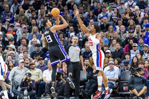 Sacramento Kings forward Keegan Murray (13) attempts to shoot over Detroit Pistons guard Jaden Ivey (23) during the first half of an NBA basketball game Thursday, Dec. 26, 2024, in Sacramento, Calif. (AP Photo/Sara Nevis)