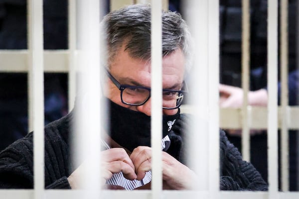 FILE - Viktar Babaryka, a former presidential hopeful, makes a heart gesture while sitting in a defendants’ cage during his trial in Minsk, Belarus, on Feb. 17, 2021. (Oksana Manchuk/BelTA Pool Photo via AP)