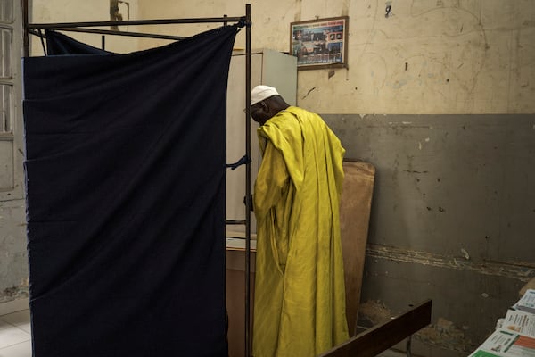 A man casts his vote for legislative elections, at a polling station in Dakar, Senegal Sunday, Nov. 17, 2024. (AP Photo/Annika Hammerschlag)