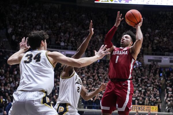 Alabama guard Mark Sears (1) shoots over Purdue forward Raleigh Burgess (34) during the first half of an NCAA college basketball game in West Lafayette, Ind., Friday, Nov. 15, 2024. (AP Photo/Michael Conroy)