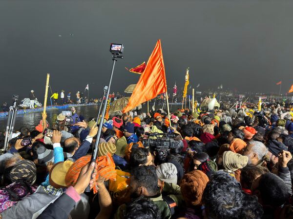 Devotees throng the banks where ascetics are bathing at the confluence of the Ganges, the Yamuna and the mythical Saraswati rivers on Makar Sankranti, an auspicious bathing day of the 45-day-long Maha Kumbh festival in Prayagraj, India, Tuesday, Jan. 14, 2025. (AP Photo/Ashwini Bhatia)