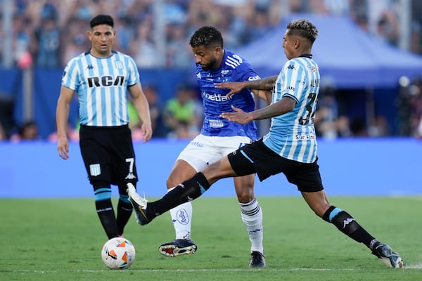 Agustin Almendra, right, of Argentina's Racing Club and Joao Marcelo of Brazil's Cruzeiro battle for the ball during the Copa Sudamericana final soccer match in Asuncion, Paraguay, Saturday, Nov. 23, 2024. (AP Photo/Jorge Saenz)