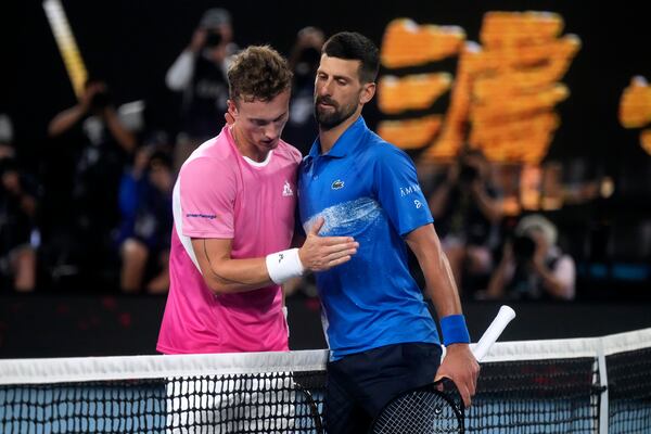 Novak Djokovic, right, of Serbia is congratulated by Jiri Lehecka of the Czech Republic, left, after their fourth round match at the Australian Open tennis championship in Melbourne, Australia, Sunday, Jan. 19, 2025. (AP Photo/Mark Baker)