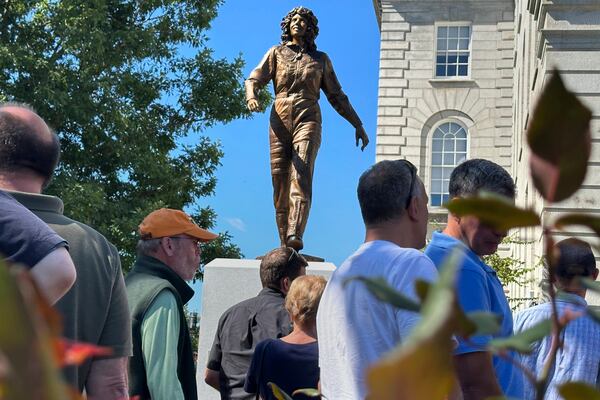 A crowd surrounds the newly-unveiled statue of Christa McAuliffe, NASA's first teacher in space, outside the Statehouse, Monday, Sept. 2, 2024, in Concord, N.H. (AP Photo/Holly Ramer, File)