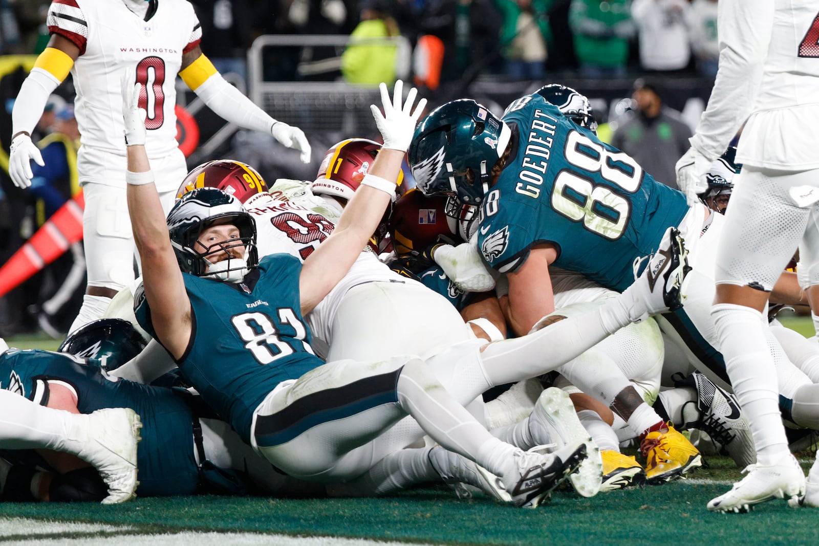 Philadelphia Eagles tight end Grant Calcaterra (81) celebrates a 1-yard touchdown by teammate Jalen Hurts during the second half of an NFL football game against the Washington Commanders Thursday, Nov. 14, 2024, in Philadelphia. (AP Photo/Laurence Kesterson)