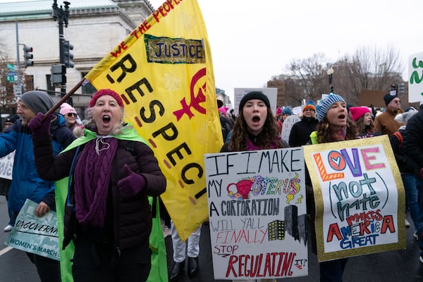 Demonstrators protest President-elect Donald Trump's incoming administration during the People's March, Saturday, Jan. 18, 2025, in Washington. (AP Photo/Jose Luis Magana)